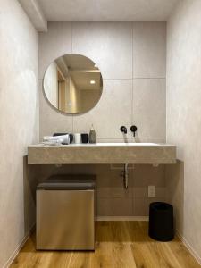 a bathroom with a sink and a mirror at Simple Hotel Tenjin Fukuoka in Fukuoka