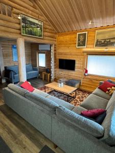 a living room with a couch and a table at Villa Hackberry Hill in Rovaniemi
