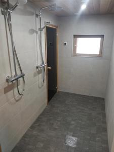 a bathroom with a shower stall and a window at Villa Hackberry Hill in Rovaniemi +27 photos