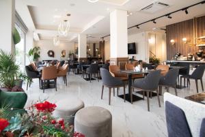 a restaurant with tables and chairs and a bar at ALEXANDRA Boutique Residence Downtown in Alexandroupoli