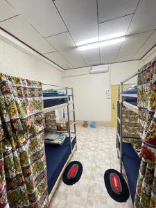 a room with bunk beds in a room with food at Catty tourist house in Thakhek +1 photo