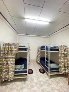 a room with two bunk beds in a room at Catty tourist house in Thakhek