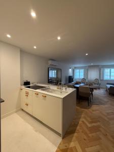 a kitchen with a sink and a living room at Luxury Duplex Apartment with terrace by Perpetual Relax in Braga