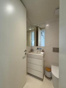 a bathroom with a sink and a mirror and a toilet at Luxury Duplex Apartment with terrace by Perpetual Relax in Braga +30 photos
