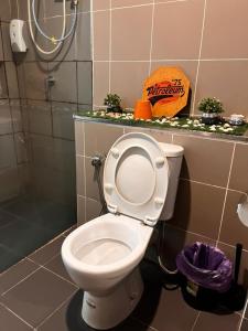 a white toilet in a bathroom with a shower at The Welcoming Nest, Aeropod in Kota Kinabalu