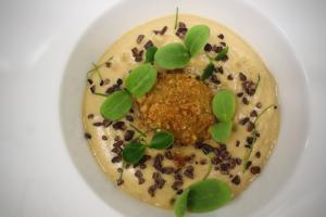 a white plate with a dessert with a plant on it at LA MASSARÌA agriresort in Orta Nova