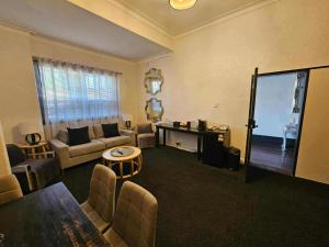 a living room with a couch and a television at Toodyay Manor in Toodyay