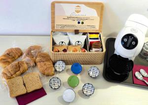 a table with a box of bread and a box of food at Tenuta57 - NUOVISSIMO B&B - IMMERSO NELLA TRANQUILLITÀ - POCHI MINUTI DAL MARE DI TERRACINA - PRIVATE PARKING - FREE WI-FI in Terracina