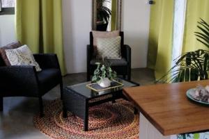 a living room with two chairs and a table at Studio Petra in Saint Francois +29 photos