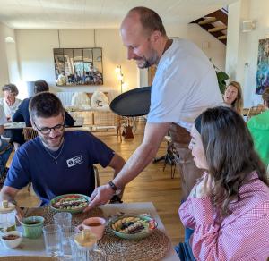 two people sitting at a table eating food at Mas Oms in Montnegre