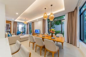a dining room with a table and chairs at Seaside Escape Villa in Cam Lâm