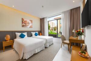 a hotel room with two beds and a window at Seaside Escape Villa in Cam Lâm +19 photos