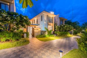 a house with a driveway in front of it at Seaside Escape Villa in Cam Lâm