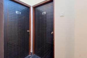 two metal doors with the numbers on them at Hotel O Chilli Pepper Hotel and Restaurant in Kolkata