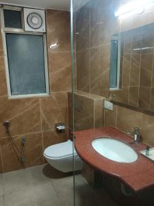 a bathroom with a sink and a toilet at The Lohmod Premier Aerocity on NH-8 Mahipalpur Delhi Airport in New Delhi +20 photos