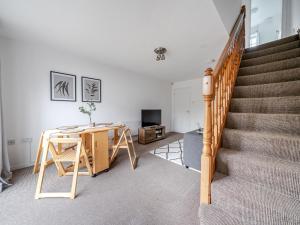 a living room with a staircase and a table at Pass the Keys Lovely 3 Bed Garden Home - Oxford in Oxford