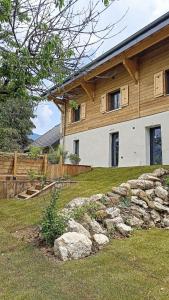 a house with a stone wall in front of it at La Grange Piscine Indoor Pool and Spa Lake Annecy in Lathuile