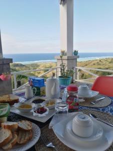 a breakfast table with a view of the ocean at Studio Amanda in Nouvelle Découverte +43 photos