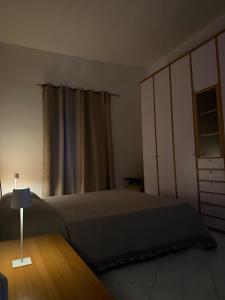 a bedroom with a bed and a dresser and a window at Terrazza sul Mare Appartamenti in Marina di Camerota