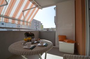 a balcony with a table with drinks on it at Harmony Apartment in Split