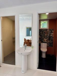 a bathroom with a sink and a toilet at Panika family room in Malaybalay +4 photos