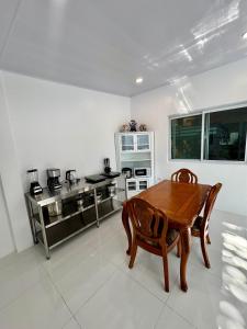 a kitchen with a wooden table and chairs in it at Panika family room in Malaybalay