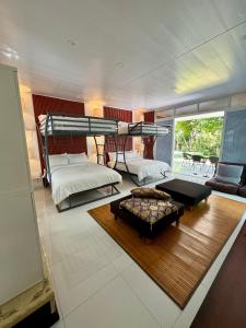 a bedroom with two bunk beds and a living room at Panika family room in Malaybalay