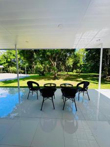 a patio with a table and chairs under a pavilion at Panika family room in Malaybalay