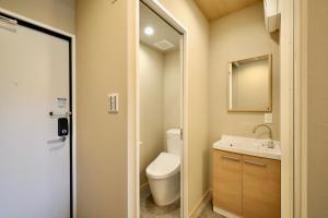 a bathroom with a toilet and a sink at NikkaHotel東郷店 in Togo +5 photos