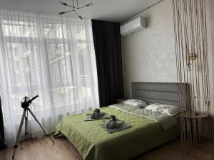 a bedroom with a bed with two rubber ducks on it at Atmosfera Sea View Apartments in Odesa