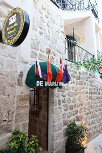 a sign for a restaurant on the side of a building at De MARİA KONAĞI in Mardin