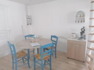 a dining room with a table and chairs at Le chalet d'Opale in Sangatte