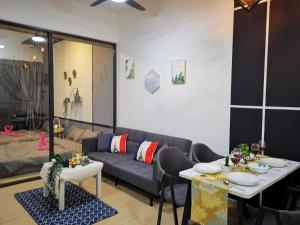 a living room with a couch and a table at Dsara Netflix tv 5 pax direct mrt next segi college in Sungai Buluh