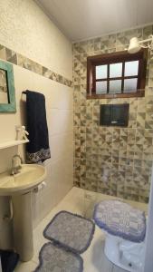 a bathroom with a sink and a toilet and a mirror at Refugio na Natureza in Santo Antônio do Pinhal +29 photos