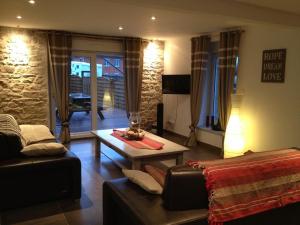 a living room with a couch and a table at la menuiserie in Jeuxey
