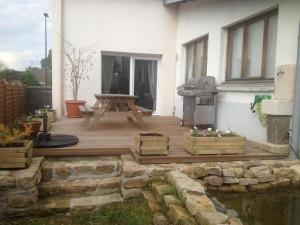 a wooden deck with a grill on the side of a house at la menuiserie in Jeuxey +13 photos