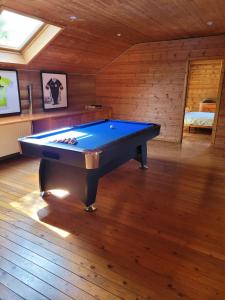 a pool table in the middle of a room at Gite de Liresse 
