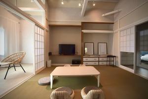 a living room with a table and a tv at the lounge Kamakura HASE in Kamakura