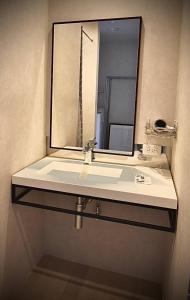 a bathroom with a sink and a mirror at the lounge Kamakura HASE in Kamakura +22 photos
