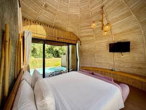 una camera da letto con un letto e una TV di Awana Villa Resort Yaonoi - SHA Extra Plus a Ko Yao Noi