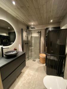 a large bathroom with a sink and a shower at Hovden Alpin Lodge Appartement in Bykle