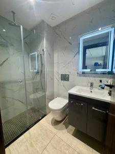 a bathroom with a shower and a toilet and a sink at Apartment in Mehdia Beach in Kenitra