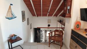 a living room with a chair and a fireplace at Summer Dream in Poros