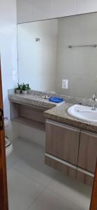 un bagno con lavandino e specchio di Vista para as Montanhas a Guarapari