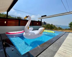 a swan float sitting on the edge of a swimming pool at Hotel Xperience in Jounieh