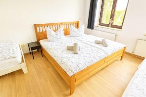 a bedroom with a large wooden bed with two pillows at TOP ANGEBOT - große Wohnung - max 6 Personen - WiFi - Waschmaschine - Badewanne - 2 Parkplätze - zentrale Lage - große Küche TOP in Chemnitz