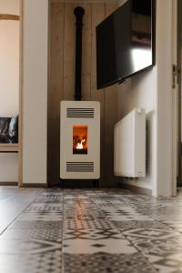 a fireplace in a room with a tile floor at Time-Out Zussen in Riemst
