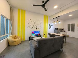 una sala de estar con un sofá y una mesa en Simfoni Comfy Premium 09, en Kuah