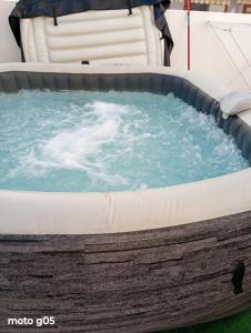 a large hot tub with blue water in it at Garajonay Atico Costa Adeje & Jacuzzi& barbacoa Gran terraza in Playa Fañabe