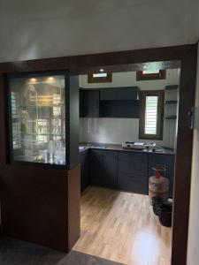 a kitchen with blue cabinets and a counter top at The Family Haven Homestay in Golāghāt +2 photos